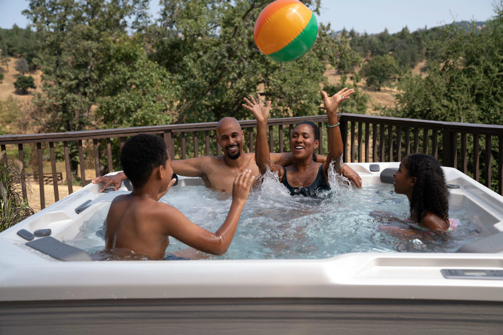 Image of family having fun in a hot tub.